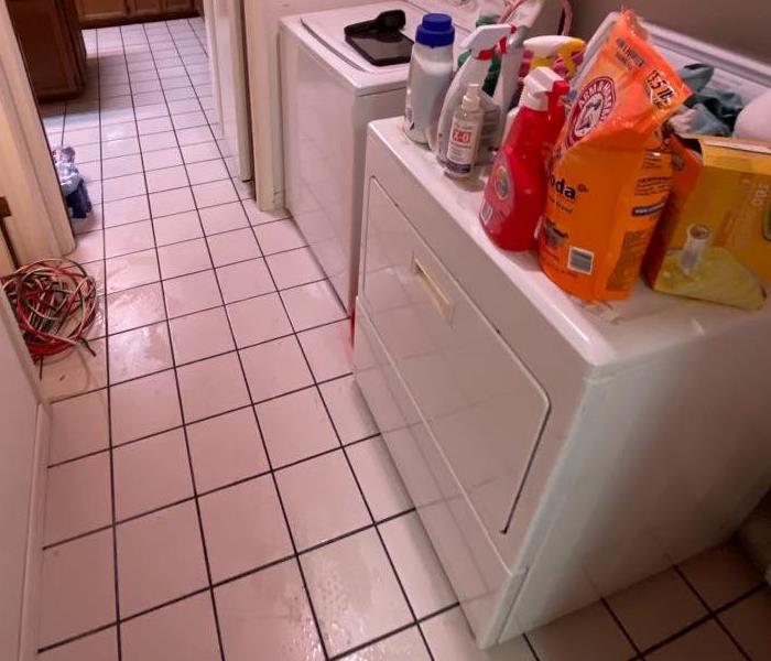 laundry room with water on the floor