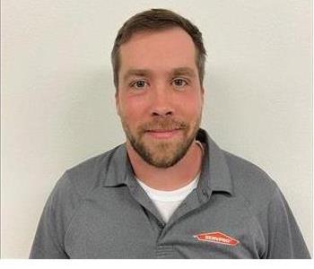 Male employee Zach Broome Pictured with a SERVPRO polo on a white background