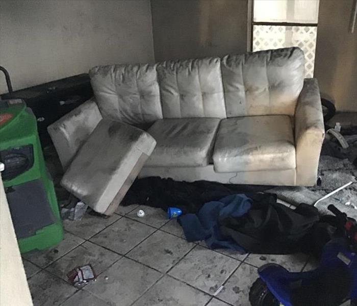 living room with items displaced and burnt from fire 