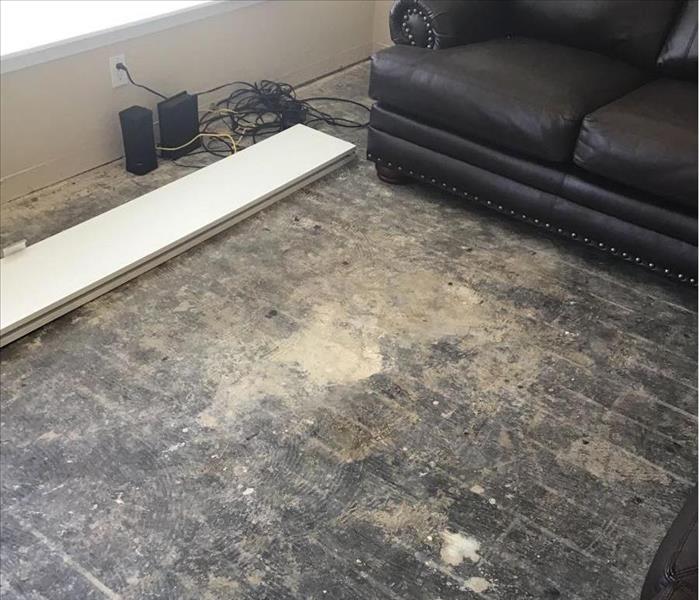 Living Room With Removed Flooring from Damage Caused by Hot Water Heater
