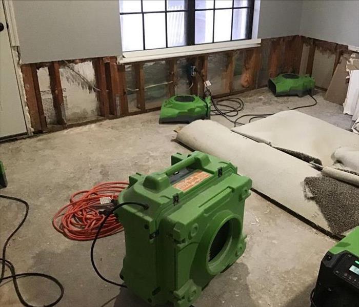 Inside of home with flood cuts in the drywall and SERVPRO equiptment 