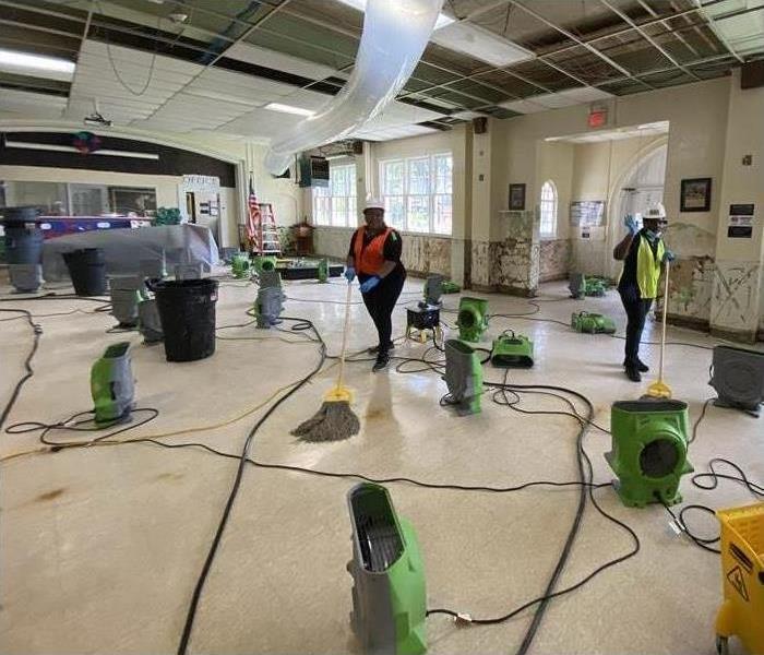Local school after water loss. SERVPRO employees inside mitigating 